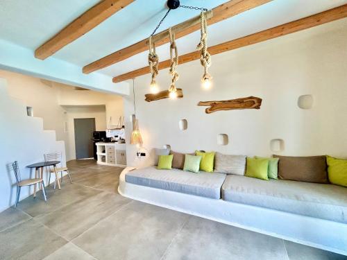 a living room with a couch and a table at Hidden Eden Residences - Private Pools in Plaka