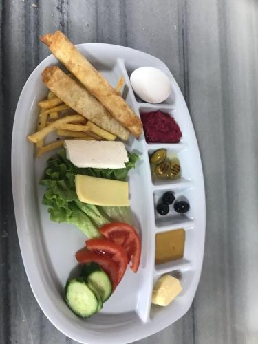 a plate of food with cheese and other food items at Kanyonpark Konaklama ve Restoran in Demirci