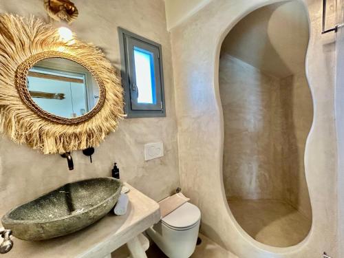 a bathroom with a sink and a mirror at Hidden Eden Residences - Private Pools in Plaka