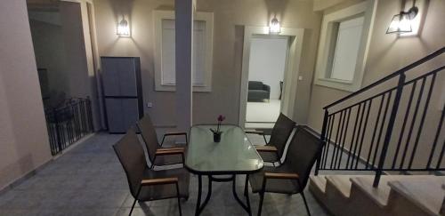 a dining room with a table and chairs in a building at Suite V in Argostoli