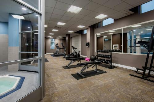 a fitness room with treadmills and a swimming pool at Residence Inn by Marriott Kingston Water's Edge in Kingston