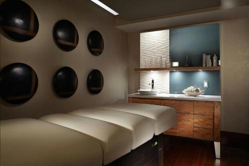 a bedroom with a large bed and a sink at Marriott Montreal Airport In-Terminal Hotel in Dorval