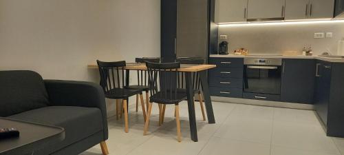 a kitchen with a table and chairs in a room at Suite V in Argostoli