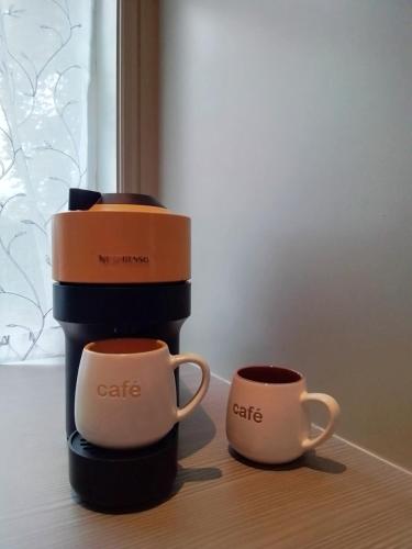 two cups of coffee are sitting on a table at Kileenlea Two bedroom Cottage in Killadoon
