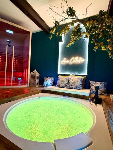 a living room with a large green pool in the middle at AMA Esclusive SPA Ariosto in Ferrara