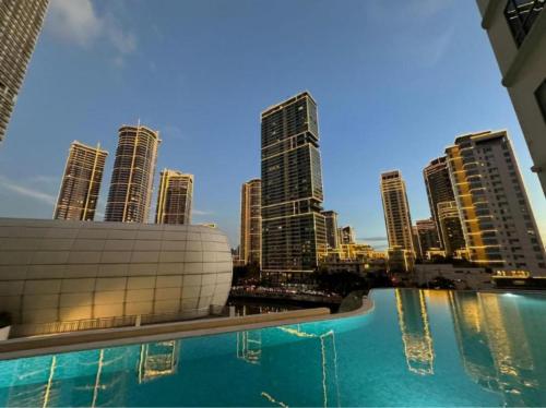 a view of a city skyline from a swimming pool at Novotel Manila Residence Hotel by Jolly Luxe Suites at Acqua in Manila