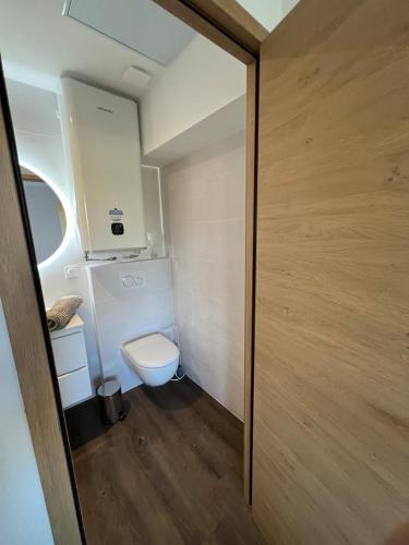 a small bathroom with a toilet and a sink at Résidence Claire Roman in Valence