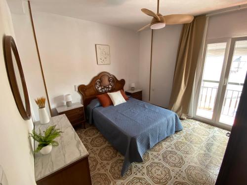a bedroom with a bed and a ceiling fan at Vivienda rural en Pegalajar in Pegalajar
