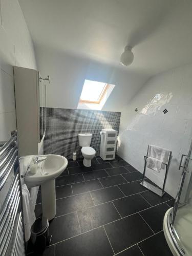 a bathroom with a sink and a toilet at Fabulous 4 Bedroom House, Gateway to Connemara in Galway