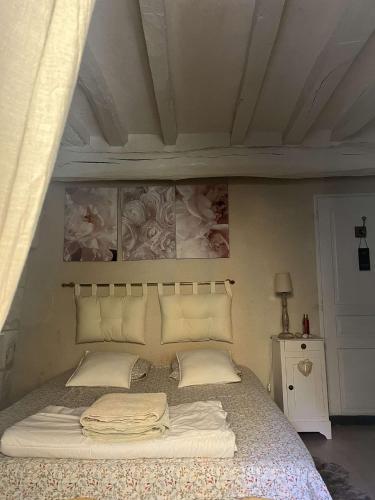 un lit avec des draps blancs et des oreillers dans une chambre dans l'établissement 272 Le Valon, à Blou