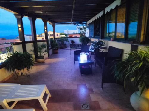 a patio with tables and chairs on a balcony at "Appartamento del Mare Gliaca" con vista Isole Eolie,ampia terrazza,wifi e parcheggio gratuito in Piraino