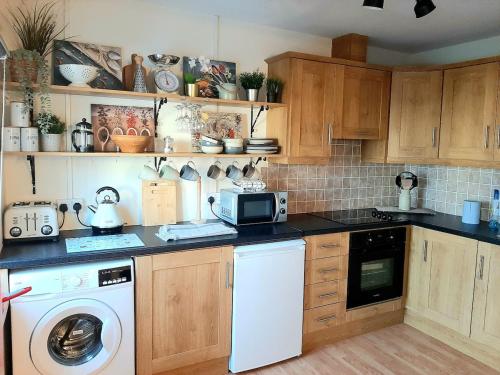 a kitchen with a washer and dryer in it at No1 Harbour view apartment Killybegs in Killybegs