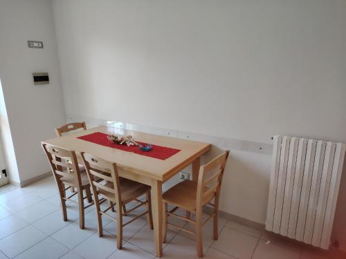 a dining room table with chairs and a radiator at B&b DI CICCONE MARIATERESA in Conza di Campania