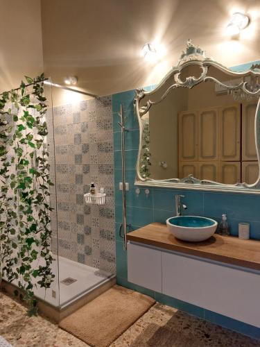 a bathroom with a sink and a mirror at LA TERRAZZA ILLUMINATA luxury ROOFTOP in Trapani