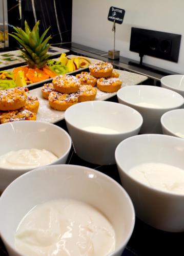a buffet with white bowls of food on a table at Sky Boutique Hotel in Perea