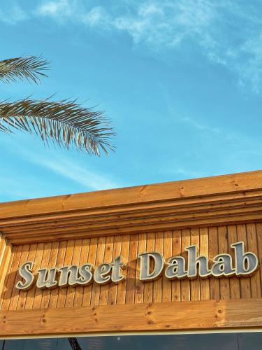 a sign on the top of a sunburst dilation sign at Sunset Luxury Dahab in Dahab