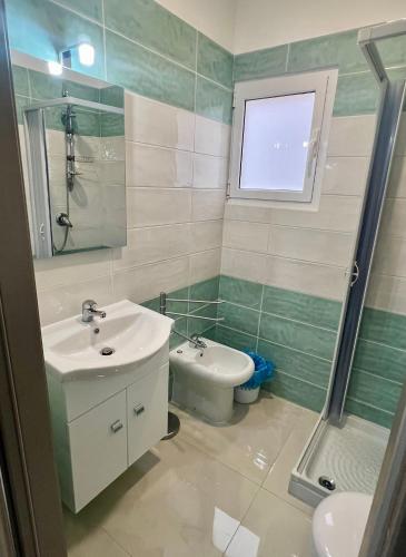 a bathroom with a sink and a toilet and a shower at Affittacamere La bottega del barbiere in Scalea