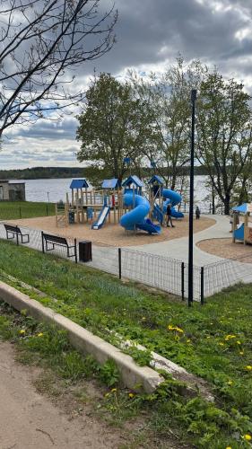 a park with a playground with slides and benches at Apartamentai KAVA in Zarasai
