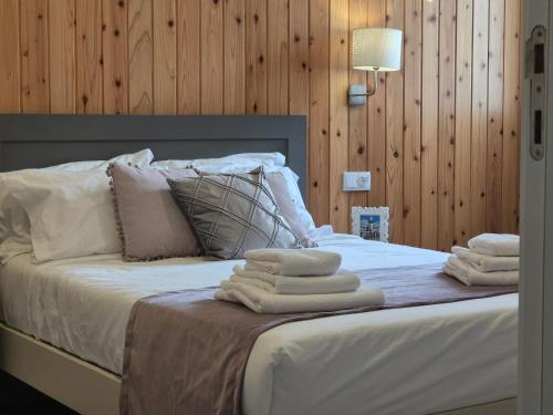 a bedroom with a bed with towels on it at Casa D'Alegria in Ponta Delgada