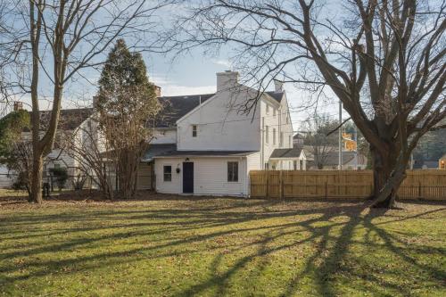 a white house with a fence in a yard at Cozy 3 Bedroom Home in Historic Kennett Square in Kennett Square
