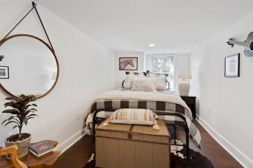 a bedroom with a bed and a large mirror at Cozy 3 Bedroom Home in Historic Kennett Square in Kennett Square