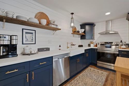 a kitchen with blue cabinets and white walls at Cozy 3 Bedroom Home in Historic Kennett Square in Kennett Square