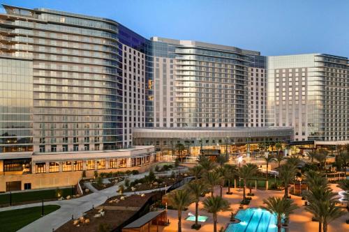 a large building with palm trees in front of it at Gaylord Pacific Resort & Convention Center in Chula Vista
