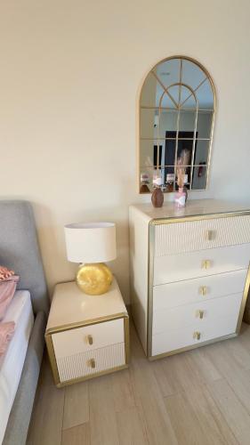 a bedroom with a dresser and a mirror at Riviera Hawana in Salalah