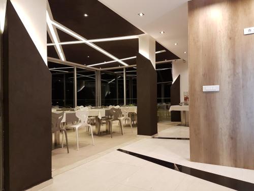 a dining room with white tables and chairs at Perla Luxury in Ulcinj