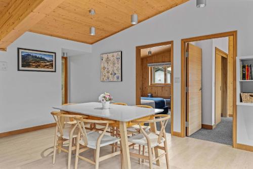 a kitchen and dining room with a table and chairs at Pyrenees #202 - LEED Gold Certified in Canmore