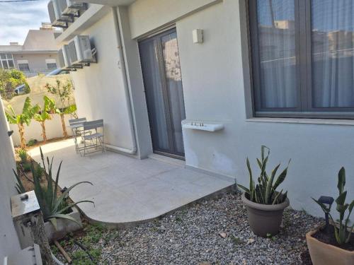 a patio with plants on the side of a building at Calmare suites in Rethymno Town