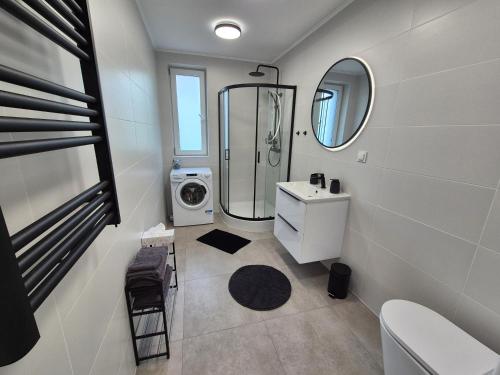 a bathroom with a sink and a washing machine at Villa Rico - Kalno in Kalno