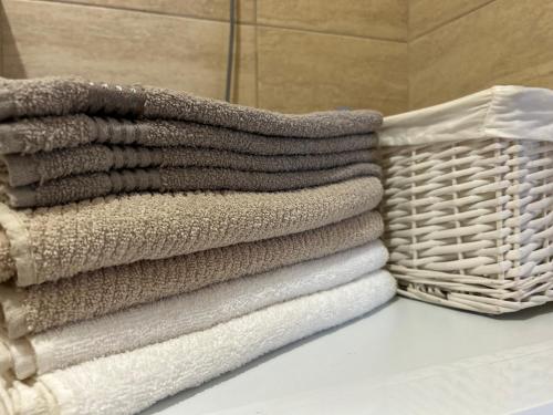 a stack of towels and a basket on a table at Cozy corner Mostar in Mostar