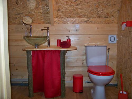 a bathroom with a sink and a toilet at Le Coeur De La Foret in Pierrefonds