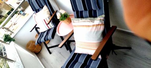 a room with a row of chairs with towels at Vigga Apartment in Golem