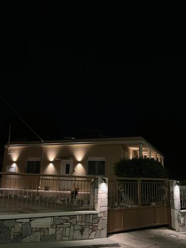 a house with lights on the side of it at night at Skyway Comfort Residences in Spáta