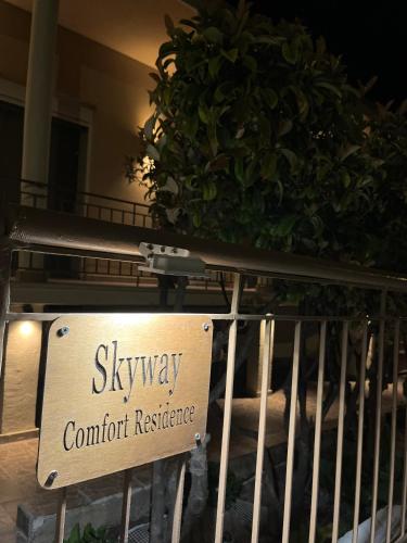 a sign that reads skyway comfort resistance on a fence at Skyway Comfort Residences in Spáta