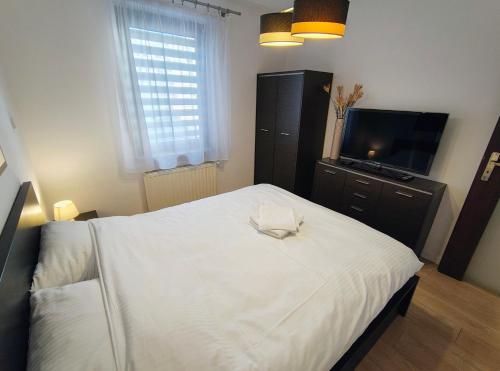 Ένα ή περισσότερα κρεβάτια σε δωμάτιο στο Tom & Jerry Apartment