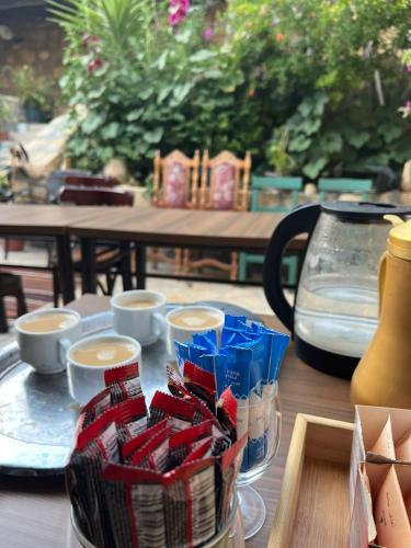 a table with a tray of cookies in a jar at Hartna zaman in Taiyiba