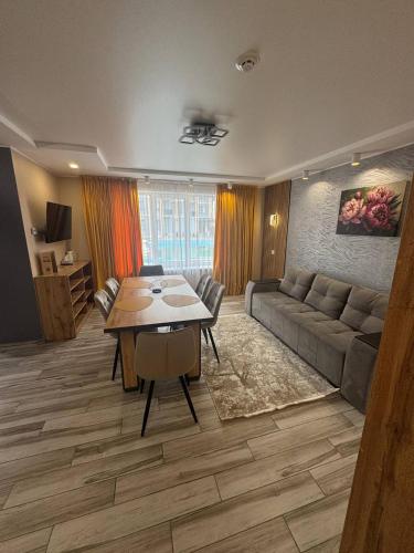 a living room with a couch and a table at Guest House Zatyshnyi Dvir in Bukovel