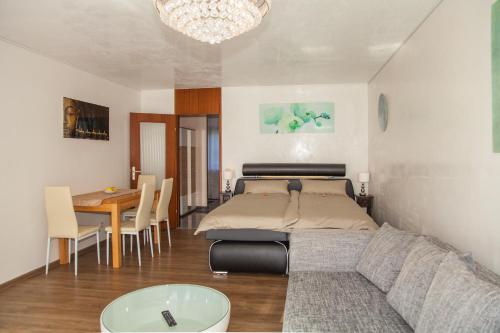 a bedroom with a bed and a table and a couch at Ferienwohnung Royal in Bad Tölz
