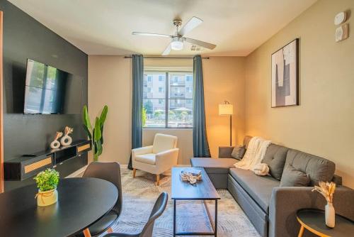 a living room with a couch and a table at Spacious 2BR Uptown Biltmore Gym Pool Parking WD in Phoenix