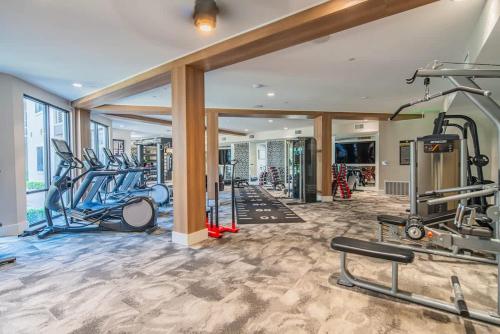 a gym with several treadmills and ellipticals at Spacious 2BR Uptown Biltmore Gym Pool Parking WD in Phoenix