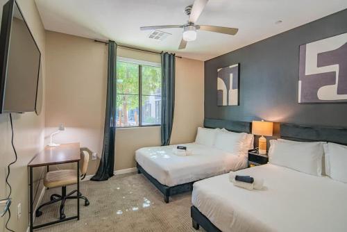 a hotel room with two beds and a television at Spacious 2BR Uptown Biltmore Gym Pool Parking WD in Phoenix