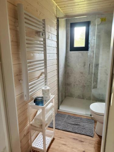 a small bathroom with a shower and a toilet at Holiday Resort Zakątek Łeba in Łeba