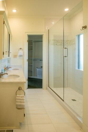 a bathroom with a glass shower and a sink at Welcome Valley Farm in Benton