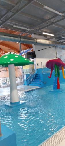 a swimming pool with two umbrellas in the water at Wellness apartmán Frymburk D403 Čtvrté patro in Frymburk