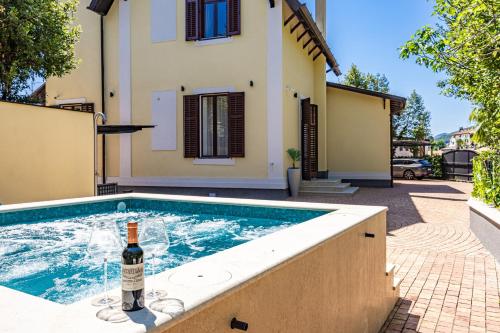 a bottle of wine sitting next to a swimming pool at Villa Accione Opatija in Opatija