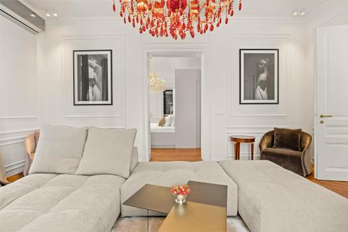 a living room with a couch and a chandelier at Villa Accione Opatija in Opatija