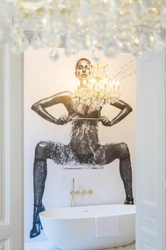 a statue of a man holding a cake with candles at Villa Accione Opatija in Opatija